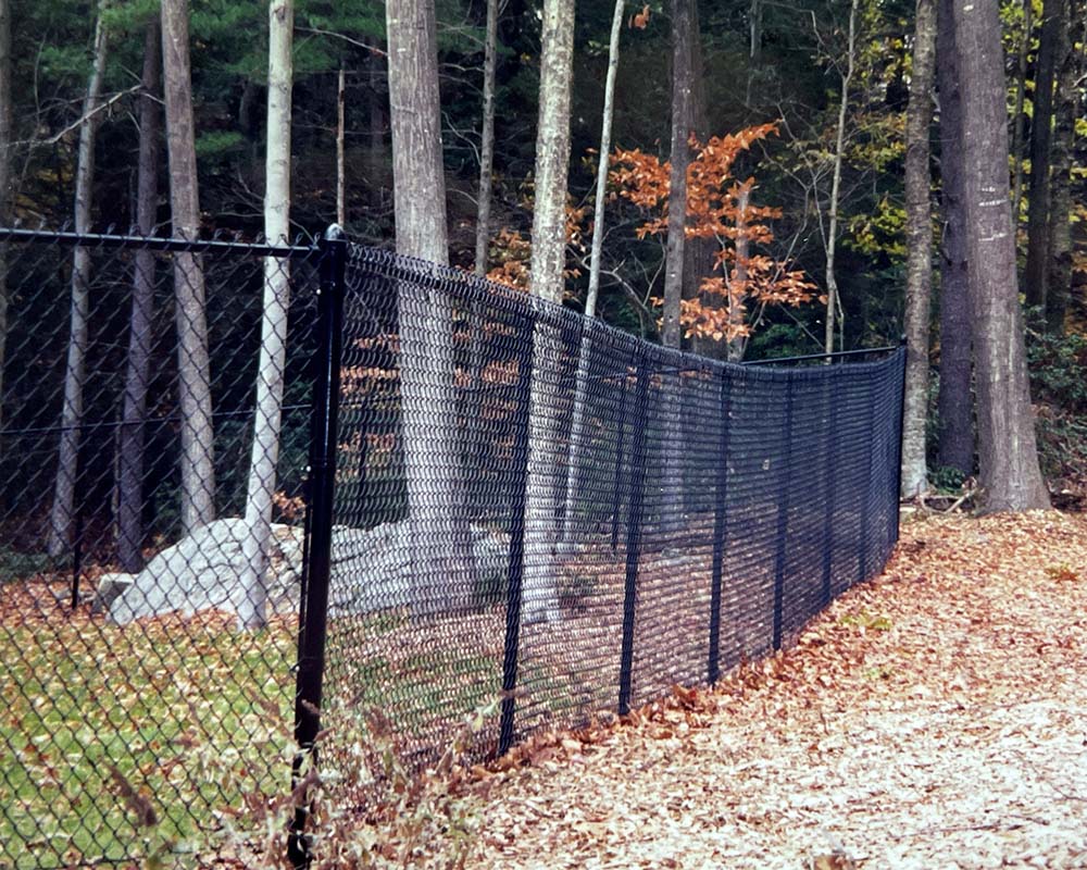 A black chain link fence near Northampton, MA by Superior Fence Contractors