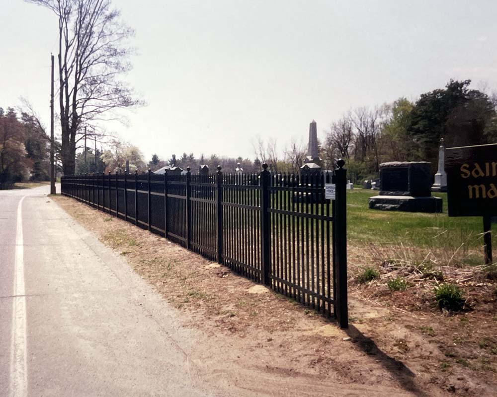 A handsome, black metal fence at a cemetary
